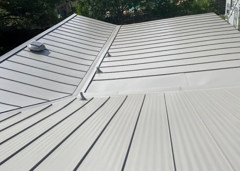 Solar attic fan installed on a metal roof for Roof Ventilation in Suffern